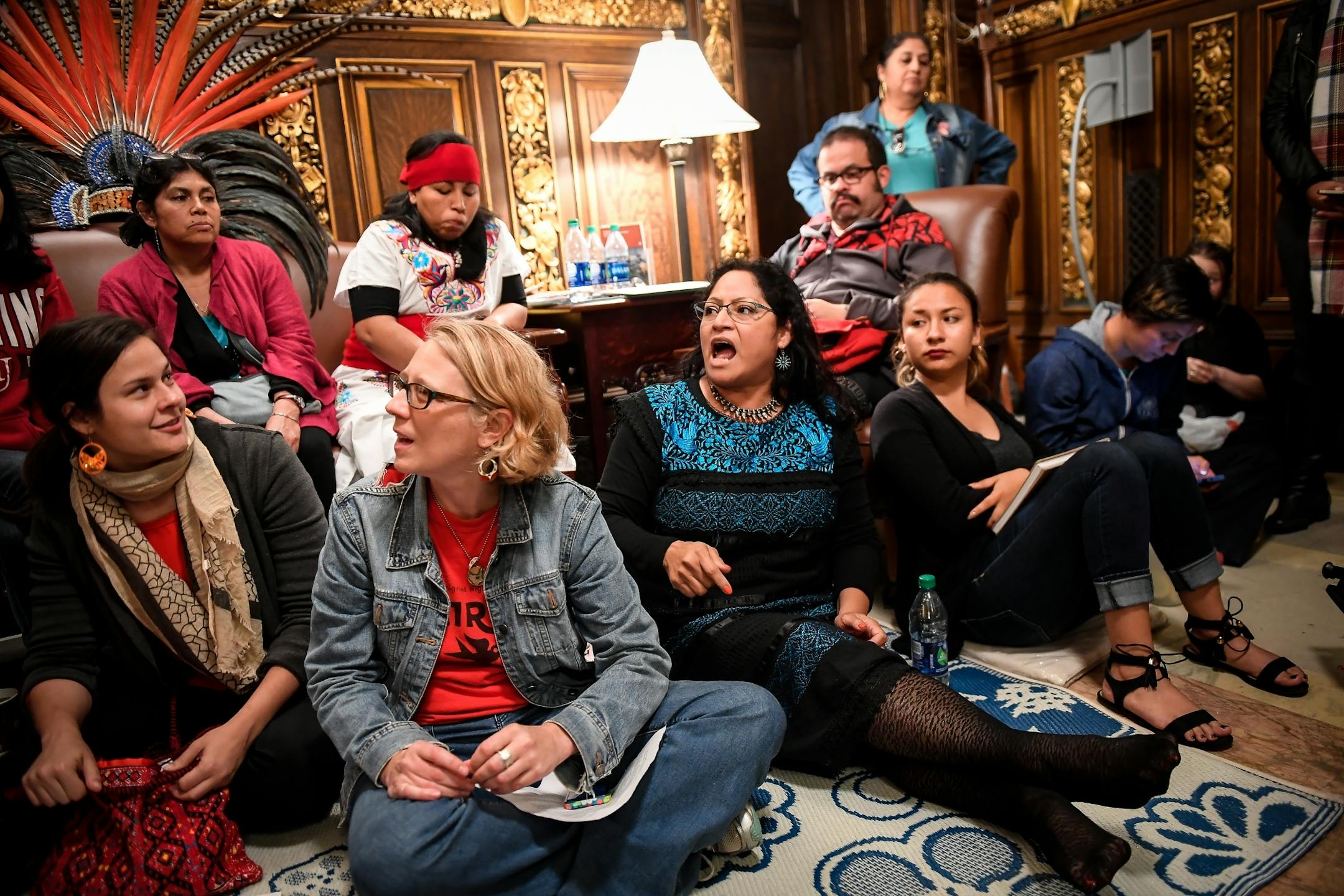 Immigrant rights protesters, including Susana de Leon, center, with the Minnesota Immigrant Rights Action Committee (MIRAC), occupied the lobby of Gov. Mark Dayton's office Tuesday evening.
