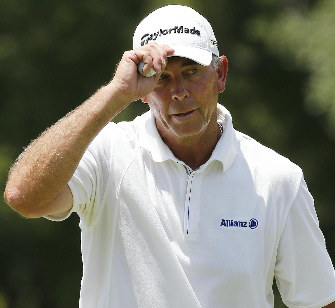 Tom Lehman tips his hat on the ninth green in the first round of play at the 2014 U.S. Senior Open golf tournament at Oak Tree National in Edmond, Okla., Thursday, July 10, 2014. (AP Photo/Sue Ogrocki) ORG XMIT: OKSO