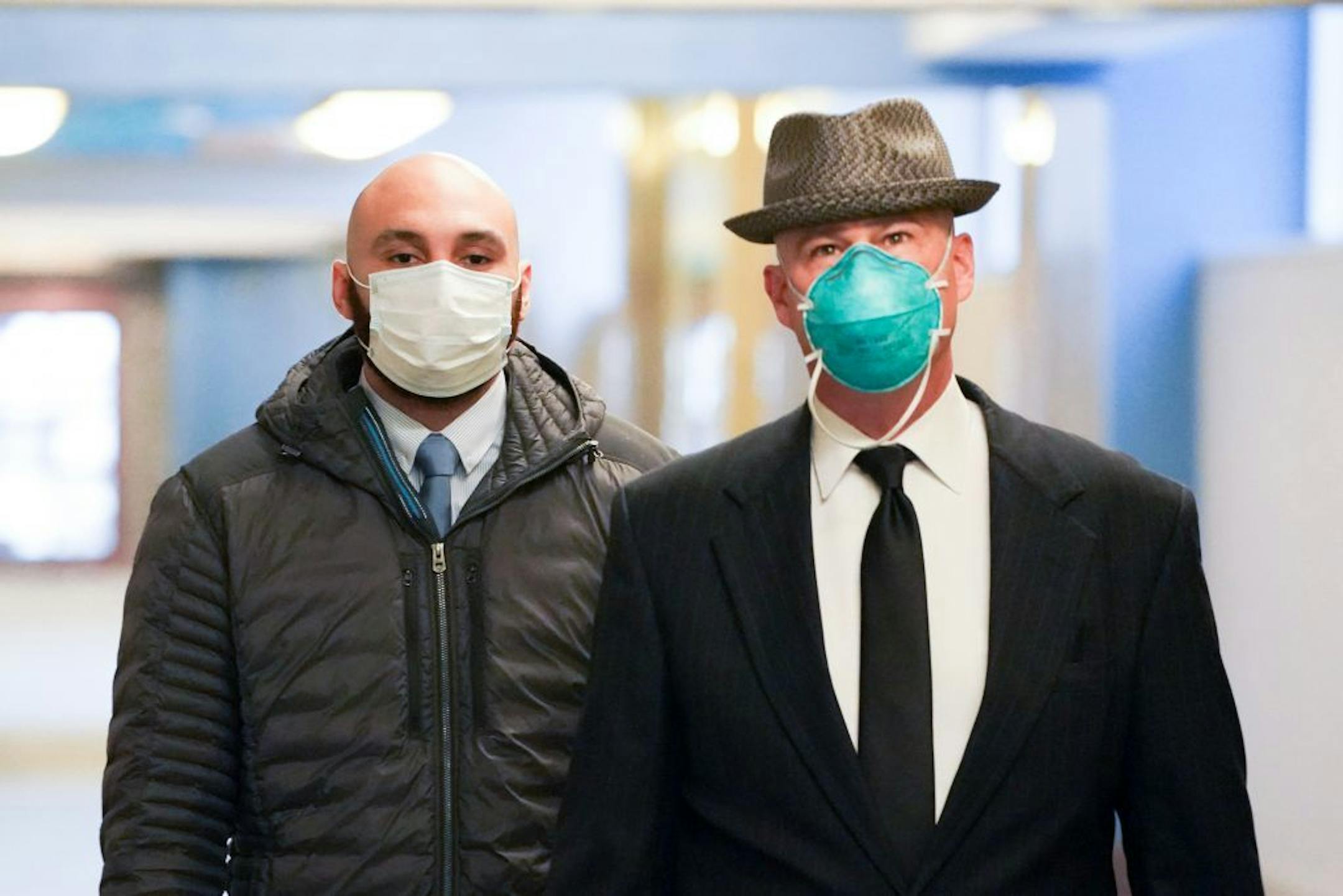 Former Minneapolis police officer J. Alexander Kueng, left, entered the Hennepin County Public Safety Facility Monday morning with his attorney Thomas Plunkett, right.