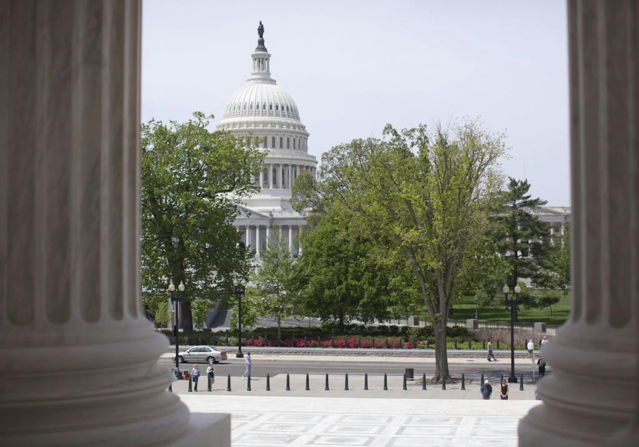 FILE - In this May 5, 2014, file photo, the Capitol building is seen through the columns on the steps of the Supreme Court in Washington. Racing the calendar, Senate leaders are pushing toward final congressional approval of a bipartisan compromise reshaping how Medicare pays physicians as Congress returns from a two-week spring recess ensnarled over domestic and foreign policy issues.