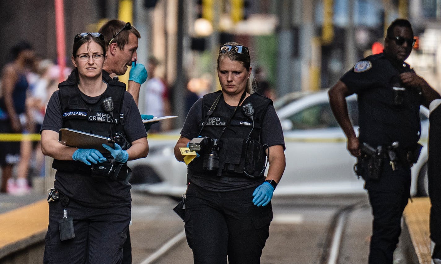 Police investigate a homicide at the 5th and Nicollet Avenue light rail station in Minneapolis, Minn., on Tuesday, Aug. 2, 2022. ] RICHARD TSONG-TAATARII • richard.tsong-taatarii@startribune.com