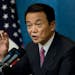 FILE - Then Prime Minister Taro Aso of Japan speaks with reporters during a news conference at the end of the financial summit in Washington, Nov. 15,