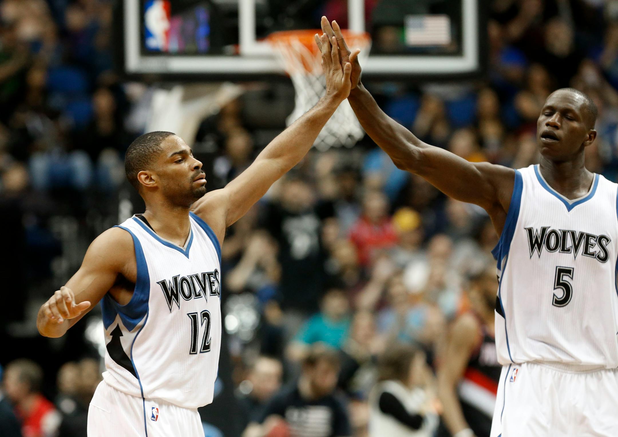 Gary Neal, left, is congratulated by Gorgui Dieng of Senegal after one of his baskets in the second half of an NBA basketball game against the Portland Trail Blazers, Saturday, March 7, 2015, in Minneapolis. The Timberwolves won 121-113. Neal came off the bench to score 27 points.