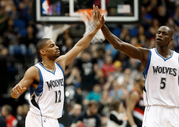 Gary Neal, left, is congratulated by Gorgui Dieng of Senegal after one of his baskets in the second half of an NBA basketball game against the Portlan