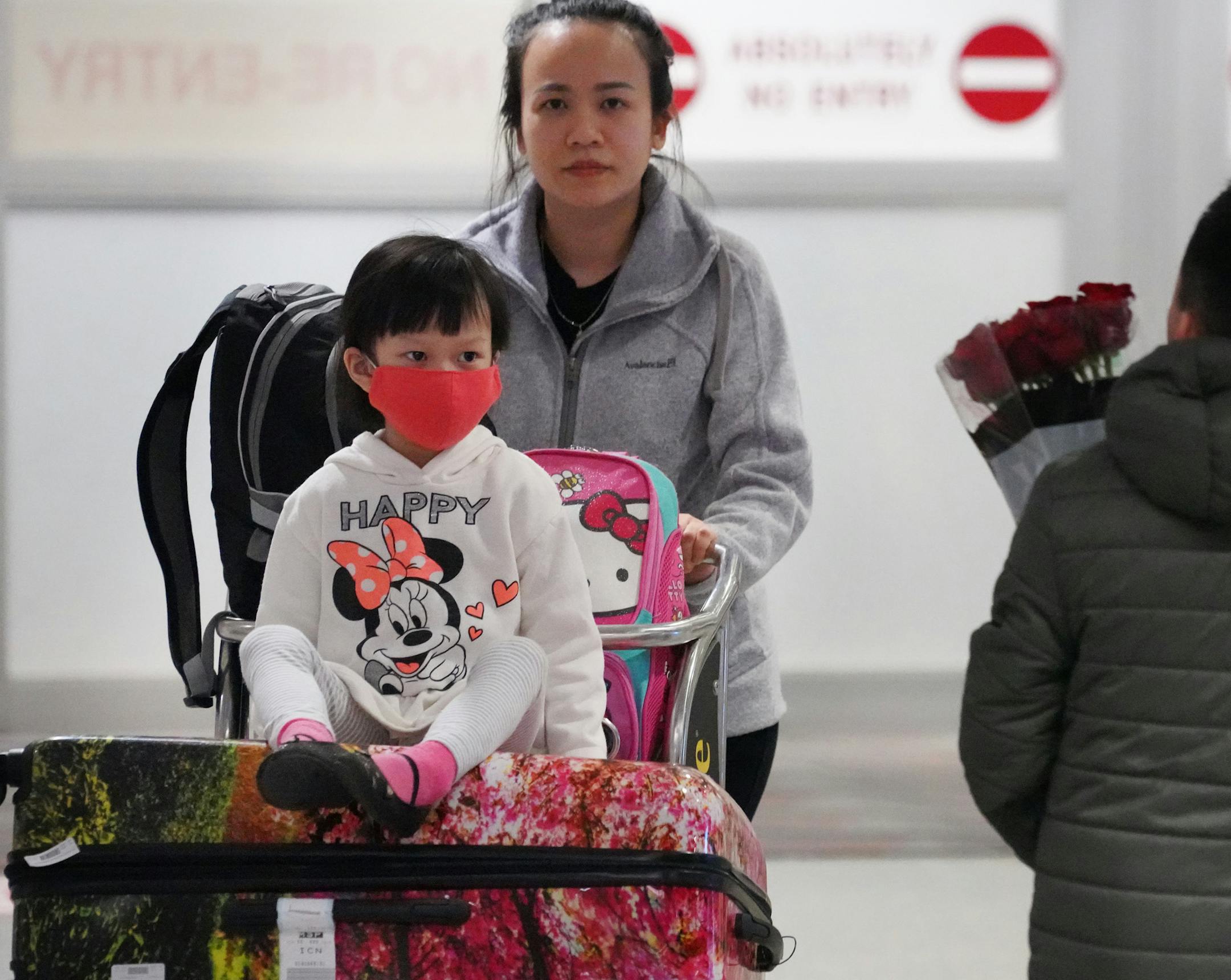 Passengers departed from Delta flight 170 from Seoul South Korea, second to last flight from Korea. (Delta is suspending direct flights from Seoul for a few weeks while coronavirus is raging. Here, Vlia Thao (right) waits, with her son, for her father Thai who was on the flight from Seoul. Most passengers coming off the flight were wearing masks.]
brian.peterson@startribune.com
Minneapolis, MN Friday, February 28, 2020