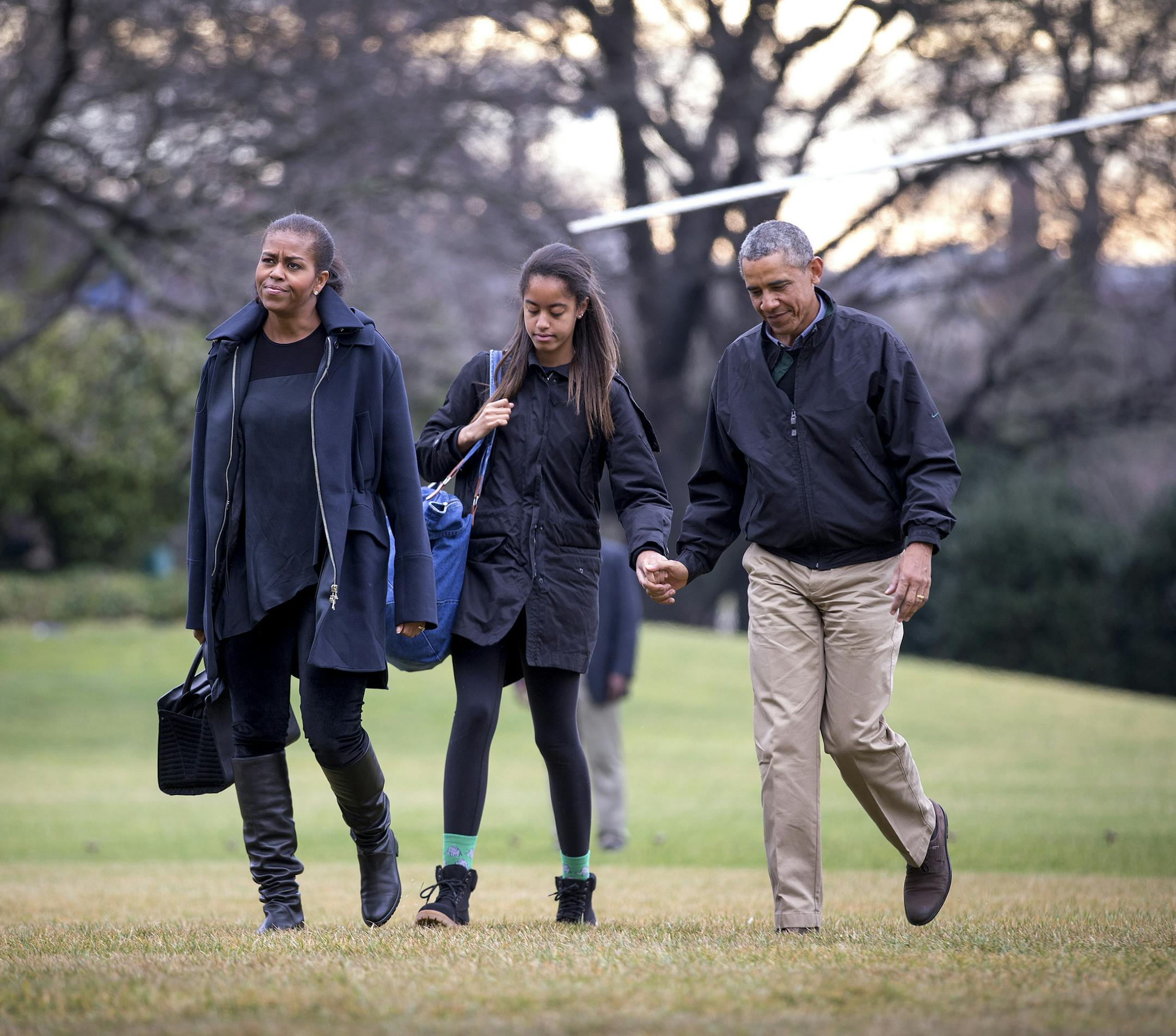 President Barack Obama walks with his daughter Malia and first lady Michelle Obama, as they arrive back at the White House following their two week vacation in Hawaii, in Washington, Jan. 4, 2015. Sasha Obama was walking ahead. Obama was rarely seen in public during the trip and spent his time golfing, on the beach with family or dining in Honolulu’s restaurants. (Doug Mills/ The New York Times)