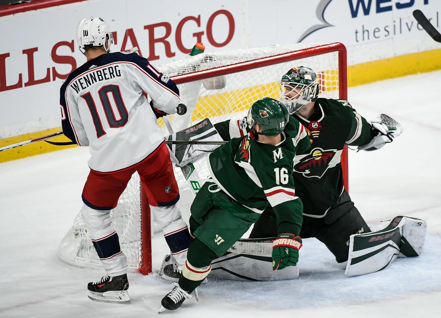 Minnesota Wild left wing Jason Zucker (16) was knocked off his feet as Columbus Blue Jackets center Alexander Wennberg (10) scored the game-winning goal in overtime