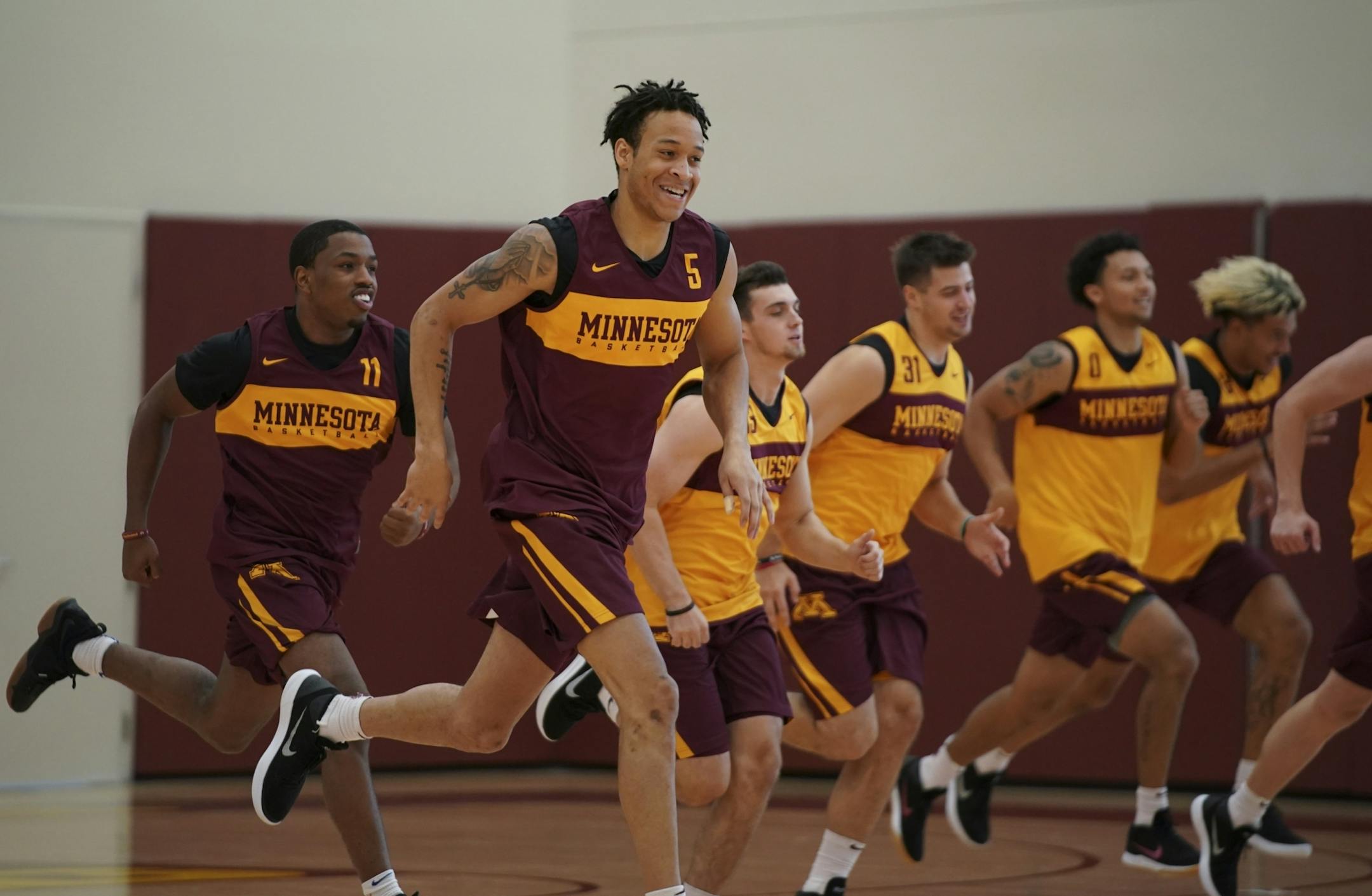 Junior guard Amir Coffey (5), shown running sprints with the rest of the team, is at full strength for the upcoming season.