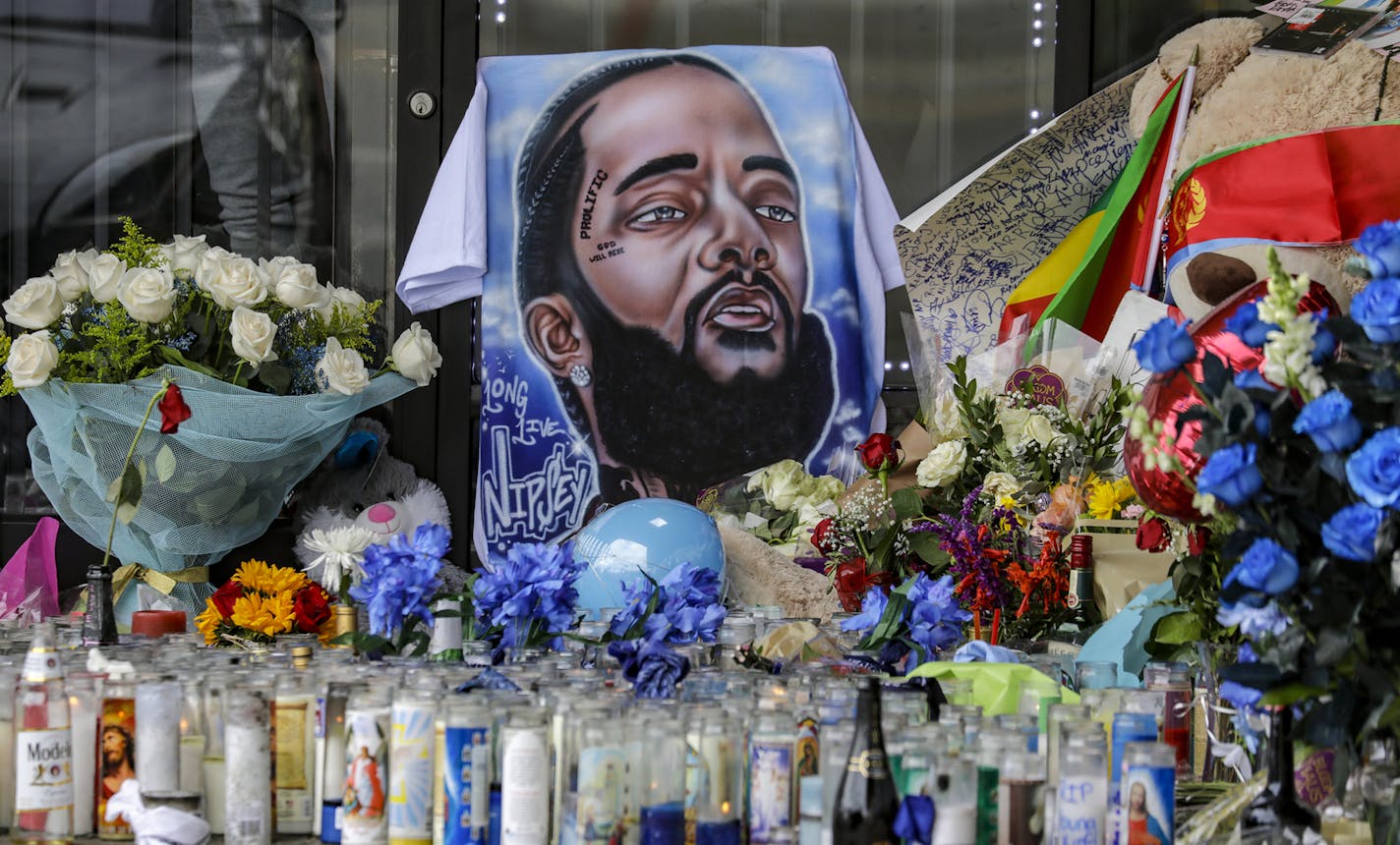 Mourners visit makeshift memorial for Nipsey Hussle at his The Marathon and shooting scene on Slauson Avenue on April 02, 2019 in Los Angeles. (Irfan Khan/Los Angeles Times/TNS) ORG XMIT: 1294227