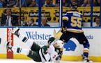 The Wild's Charlie Coyle fell while chasing after a loose puck with the Blues' Colton Parayko during the first period in Game 3 Sunday.