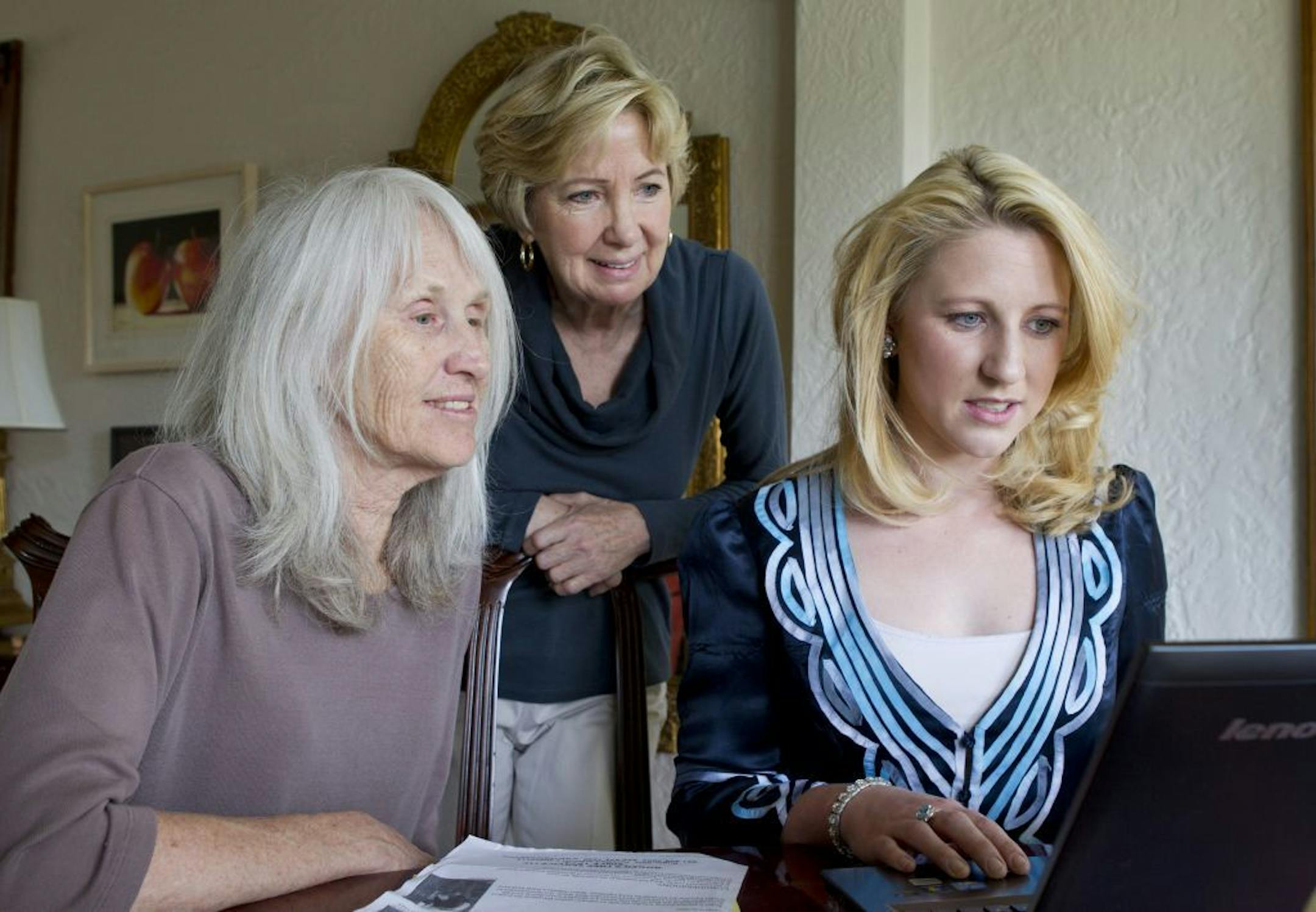 Sara Olson, left, works with her daughter Leila Peterson, right, and Mary McLeod, center, on a petition to the Obama White House to reduce disparities in prison sentences for crack and powder cocaine Saturday, May 25, 2013, in St. Paul, Minn.
