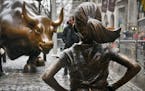 The "Fearless Girl" statue, created by Kristen Visbal, stands across from the "Charging Bull" statue, Monday, March 27, 2017, in New York. Mayor Bill 