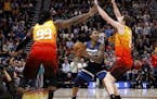 The Jazz's Jae Crowder (99) and Joe Ingles defended as Timberwolves guard Jeff Teague looked to pass during the first half Friday.