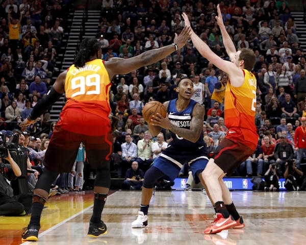 The Jazz's Jae Crowder (99) and Joe Ingles defended as Timberwolves guard Jeff Teague looked to pass during the first half Friday.