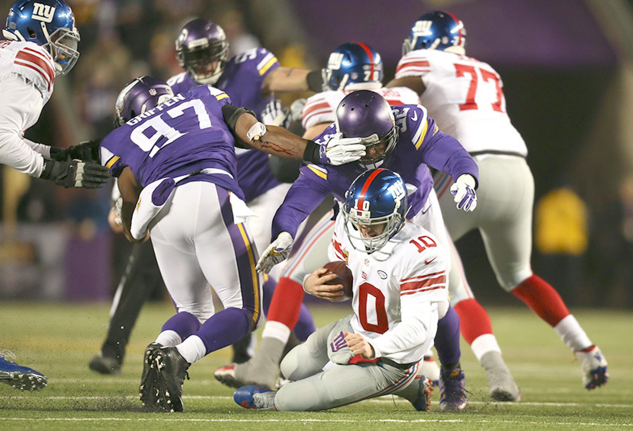 Giants quarterback Eli Manning (10) was sacked for an eight yard loss by Vikings defensive tackle Tom Johnson (92) in the second quarter Sunday night. Giants' Ereck Flowers, left, was penalized on the play for unnecessary roughness.