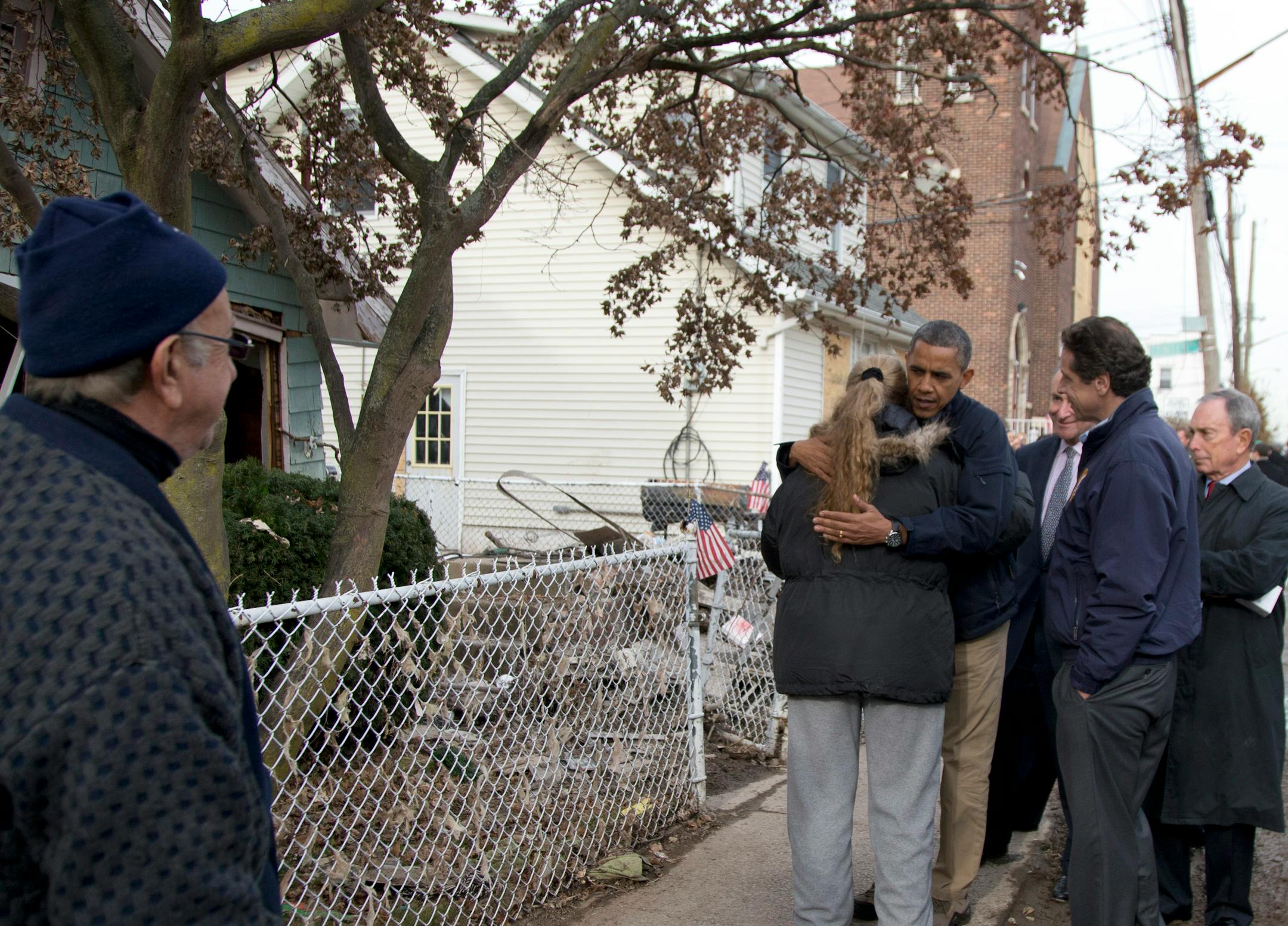 President Barack Obama, accompanied by New York City Mayor Michael Bloomberg, New York Gov. Andrew Cuomo and Sen. Charles Schumer, D-N.Y., hugs Debbie Ingenito on Cedar Grove Avenue, a street significantly impacted by Superstorm Sandy, Thursday, Nov. 15, 2012, on Staten Island, in New York. (AP Photo/Carolyn Kaster)