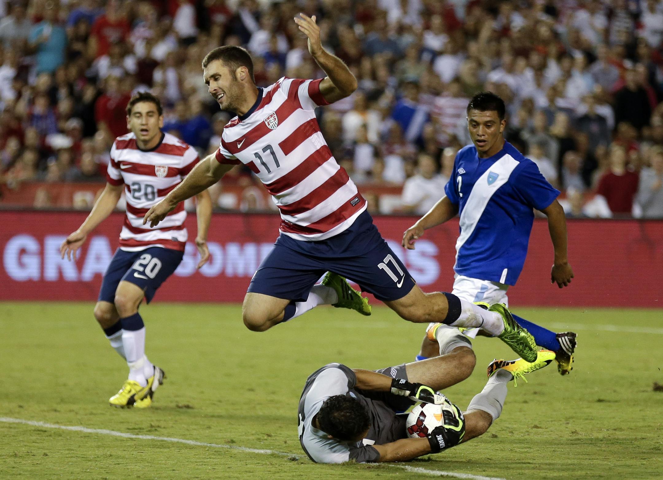 The United States' Will Bruin (17) leaps over Guatemala goalkeeper Ricardo Jerez, below, in the second half during an international friendly soccer match Friday, July 5, 2013, in San Diego. (AP Photo/Gregory Bull)