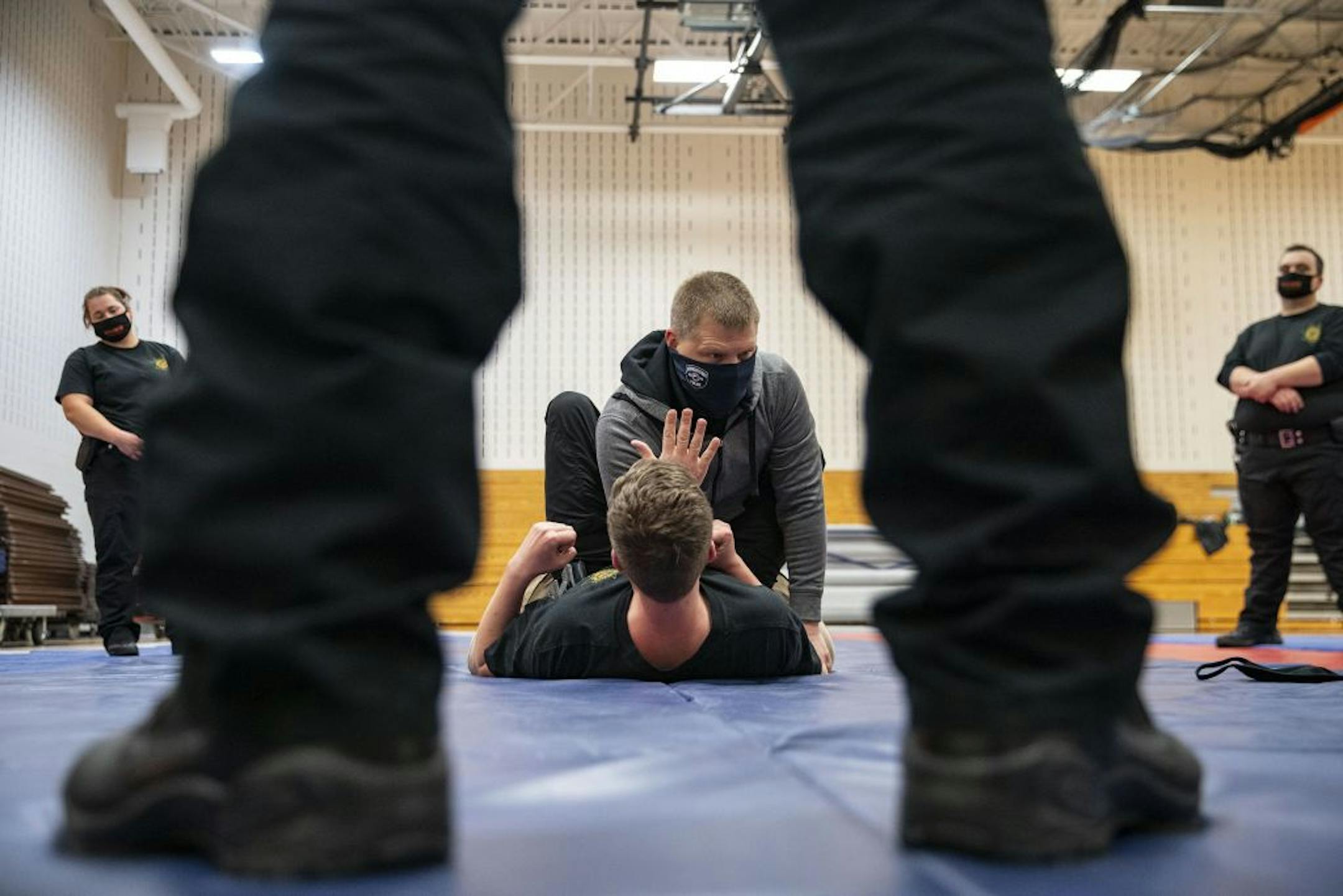 Jason Salo, a Hermantown police officer and law enforcement coordinator, demonstrated proper ground fighting technique with trainee Collin O'Toole during defensive tactics class at Fond Du Lac Tribal and Community College in Cloquet, Minn. on Tuesday November 17, 2020.