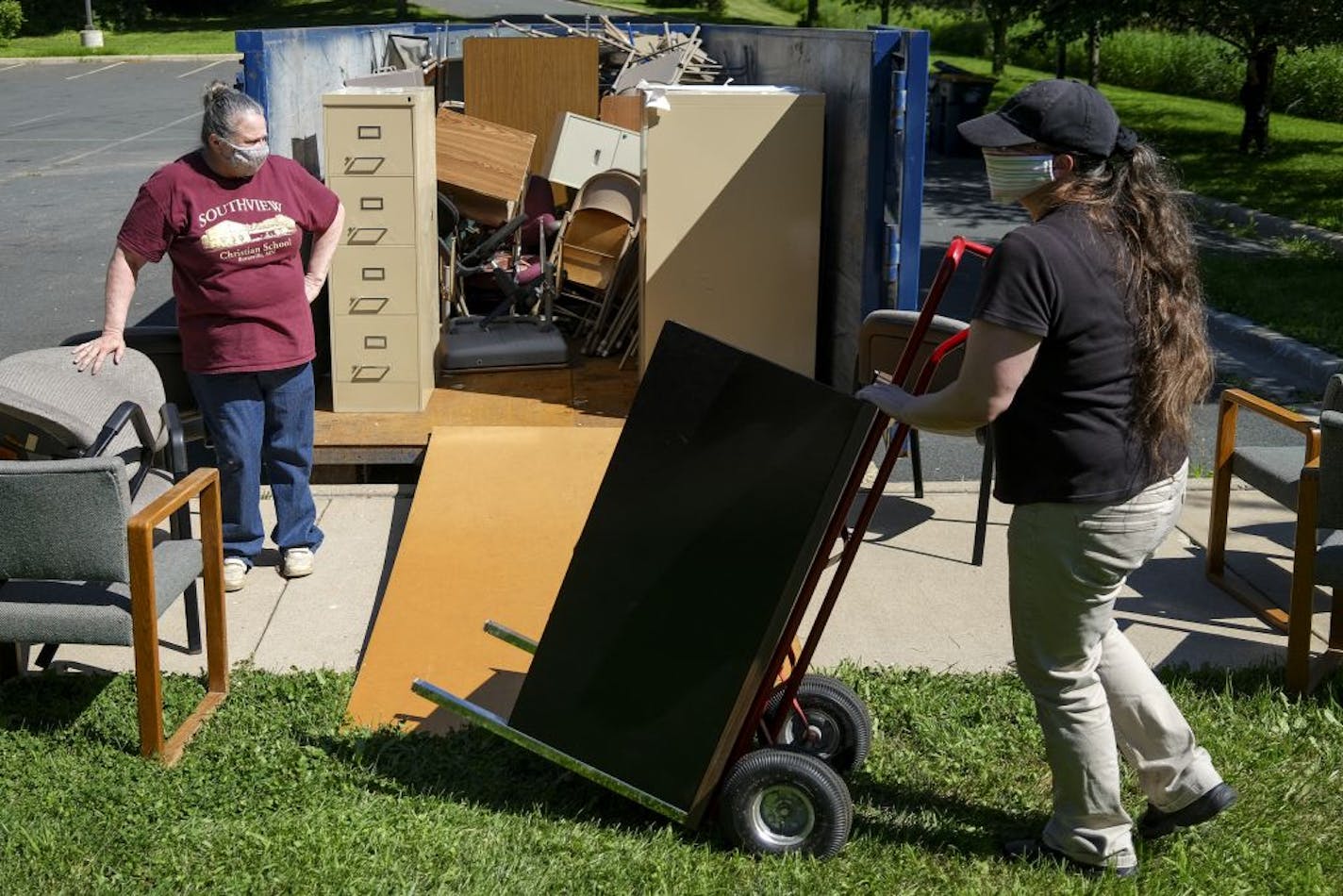 Southview Christian School Principal and teacher Rayleen Hansen, left, spoke to her daughter and fellow teacher Brooke Hansen as they prepared the school for a new year Wednesday afternoon by removing some old furniture and storage.