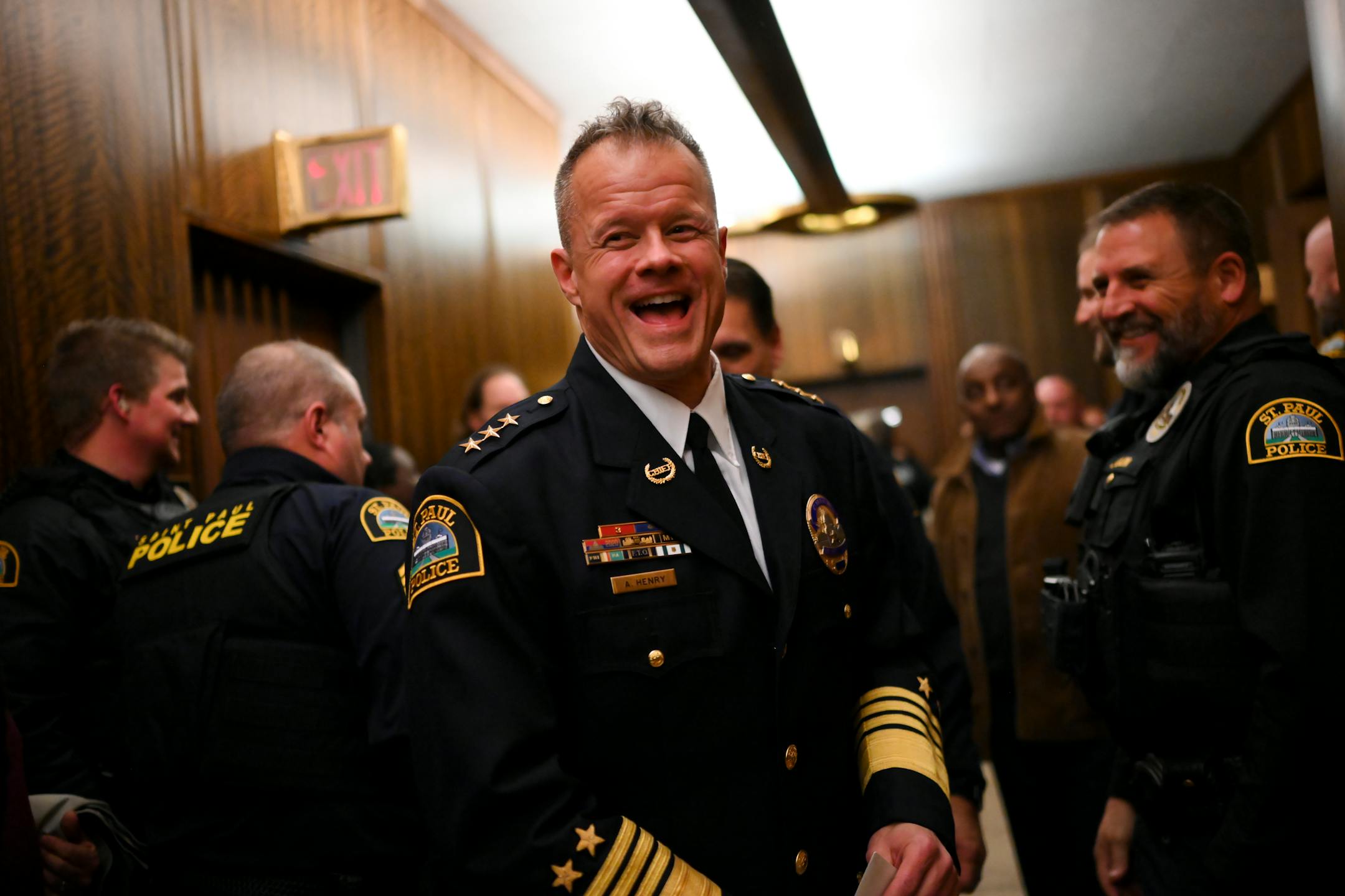 Newly sworn-in St. Paul Police Chief Axel Henry is all smiles as he's greeted by fellow St. Paul Police after he was unanimously confirmed by city council Wednesday, Nov. 16, 2022 at St. Paul City Hall in St. Paul, Minn..