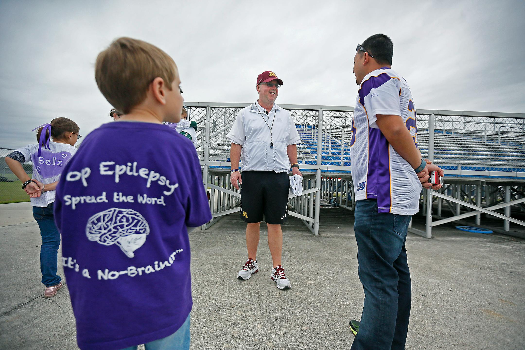 In this 2014 file photo, Gophers football coach Jerry Kill was greeted by epilepsy patients after practice at Freedom High School on Dec. 26, 2014, in Orlando, Fla.