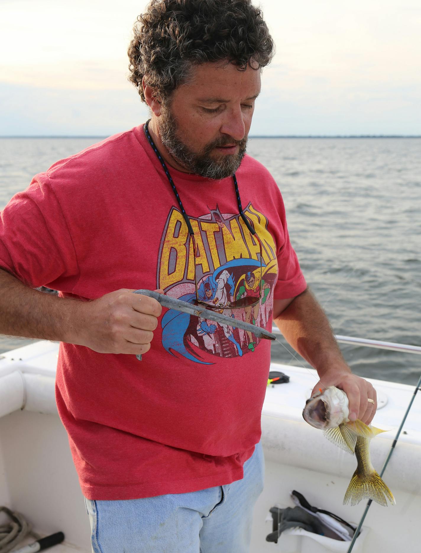 Mike Giefer of Woodbury prepares to remove a hook from a Mille Lacs walleye before releasing the fish back into the lake.