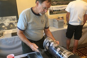 Gary Gentz, 72, of Eustace, Tex., looks through photos he and others took while serving with Air America, the CIA-controlled airline, during the Vietn