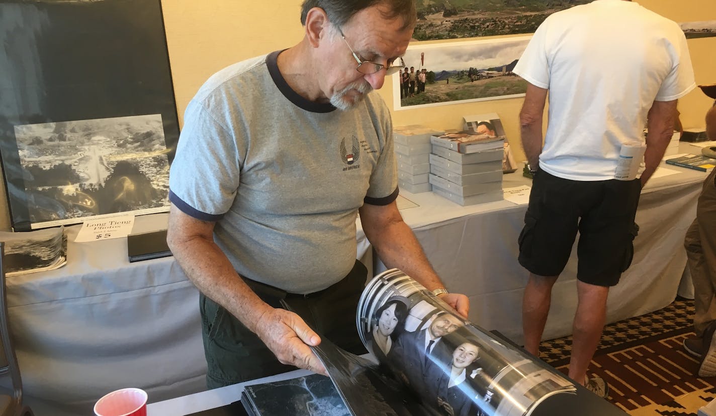 Gary Gentz, 72, of Eustace, Tex., looks through photos he and others took while serving with Air America, the CIA-controlled airline, during the Vietnam War. Gentz was a flight mechanic on helicopters during the "Secret War" in Laos.