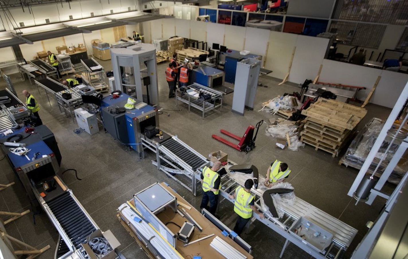 Workers installed new automatic screening lanes in the south checkpoint at the Minneapolis-St. Paul International Airport. The four lanes will be available for first class and pre check travelers.