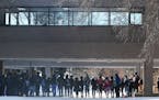 Minneapolis North students stand solemnly in a circle in the school's courtyard after walking out of school and linking arms and holding hands. Florid
