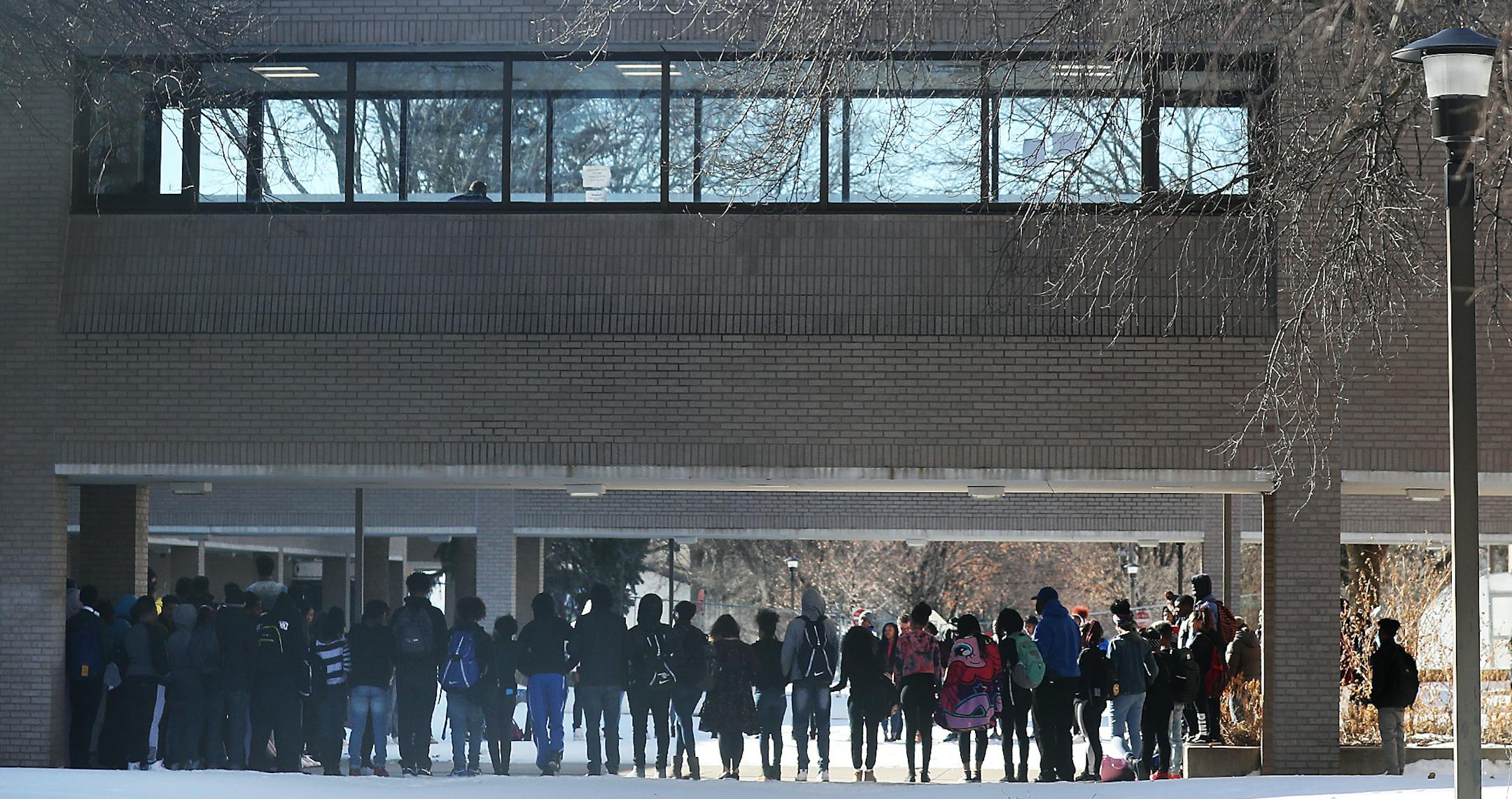 Minneapolis North students stand solemnly in a circle in the school's courtyard after walking out of school and linking arms and holding hands. Florida school shooting victims were named at the end of the of the 17 minutes Wednesday, March 14, 2018, in Minneapolis, MN. At other schools in Minnesota and across the nations some students left the school grounds.] DAVID JOLES &#xef; david.joles@startribune.com Thousands of students around the metro area will be walking out of their schools for 17 mi