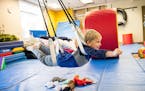 St. David's Center's new occupational therapy gyms feature a variety of swing activities for children like Felix Haar, 5.