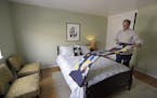 In this Friday, Oct. 16, 2015, photo, Bruce Bennett folds a blanket in a room that he makes available to rent via Airbnb in his home in San Francisco.