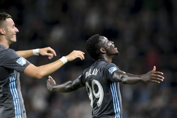 Minnesota United midfielder Jan Gregus (8), left, celebrated with forward Abu Danladi (99) after Danladi's goal against Orlando City during stoppage t