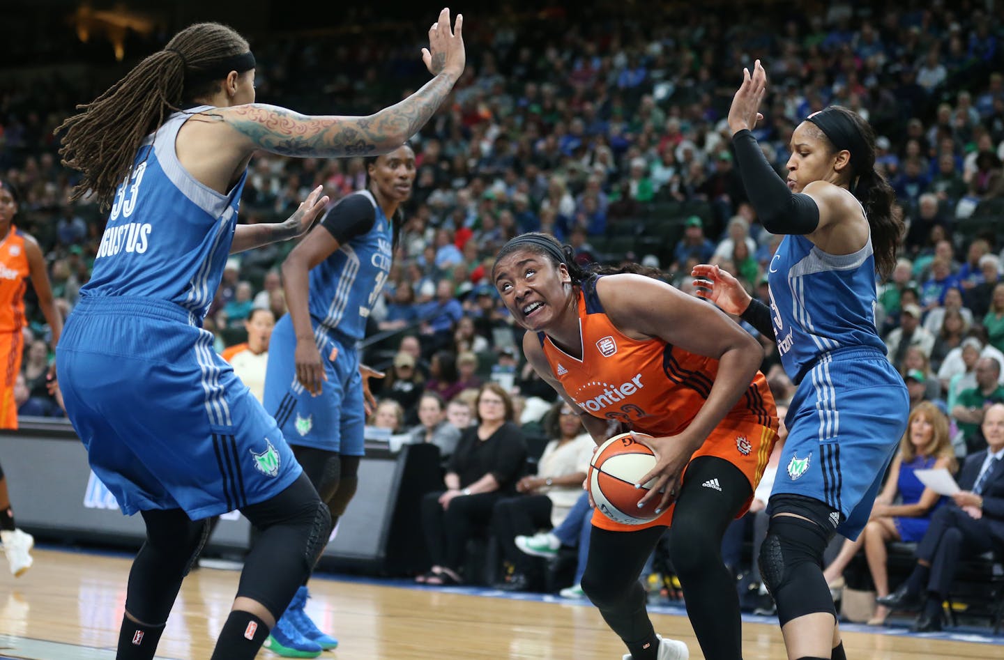 Connecticut Sun forward Morgan Tuck (33) looked for the basket over Minnesota Lynx guard Seimone Augustus (33) and Maya Moore