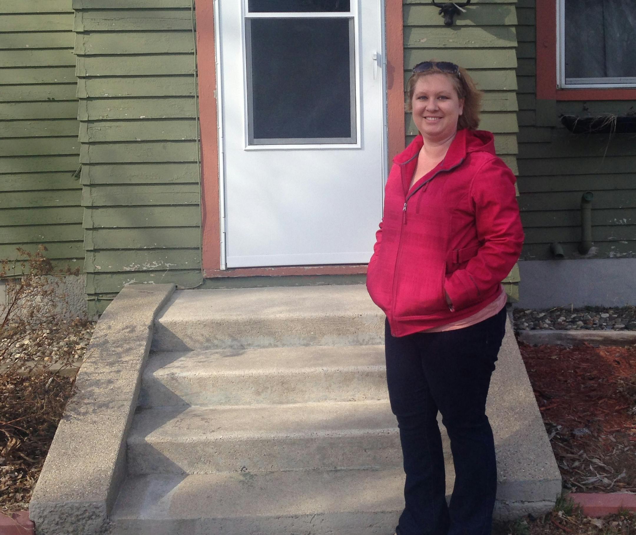 Aubrey Johnson stands in front of the house of her father, Mayor Albert Gates. She doesn't understand why Council Member Scott Vold would file a restraining order against him.