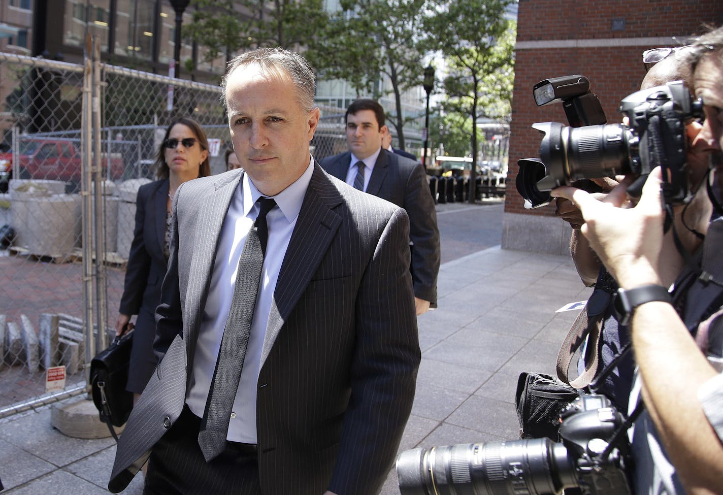 Barry Cadden, president of the New England Compounding Center, followed by members of his legal team, arrive at the federal courthouse for sentencing Monday, June 26, 2017, in Boston. A verdict of guilty on charges of mail fraud, racketeering conspiracy and racketeering had been reached on Wednesday, March 22, 2017 in the case of a fungal meningitis outbreak from tainted steroids manufactured by Cadden's pharmacy which killed dozens and sickened hundreds of people in 2012. (AP Photo/Stephan Savo