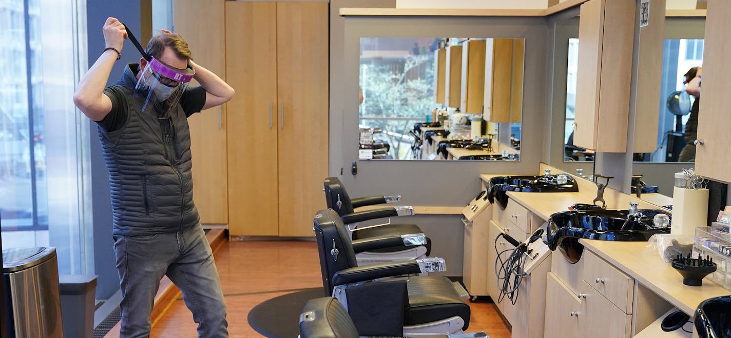 Tom Ford, owner of the Madison & Co Salon in the Canadian Pacific building, donned one of the protective face shields he'd ordered to wear while cutting hair as he stopped in to get the mail and check in on the space Wednesday. ] ANTHONY SOUFFLE • anthony.souffle@startribune.com Tom Ford, owner of the Madison & Co Salon in the Canadian Pacific building, stopped in to get the mail and check in on the space Wednesday, May 20, 2020 in downtown Minneapolis. Ford had been planning on operating at 50