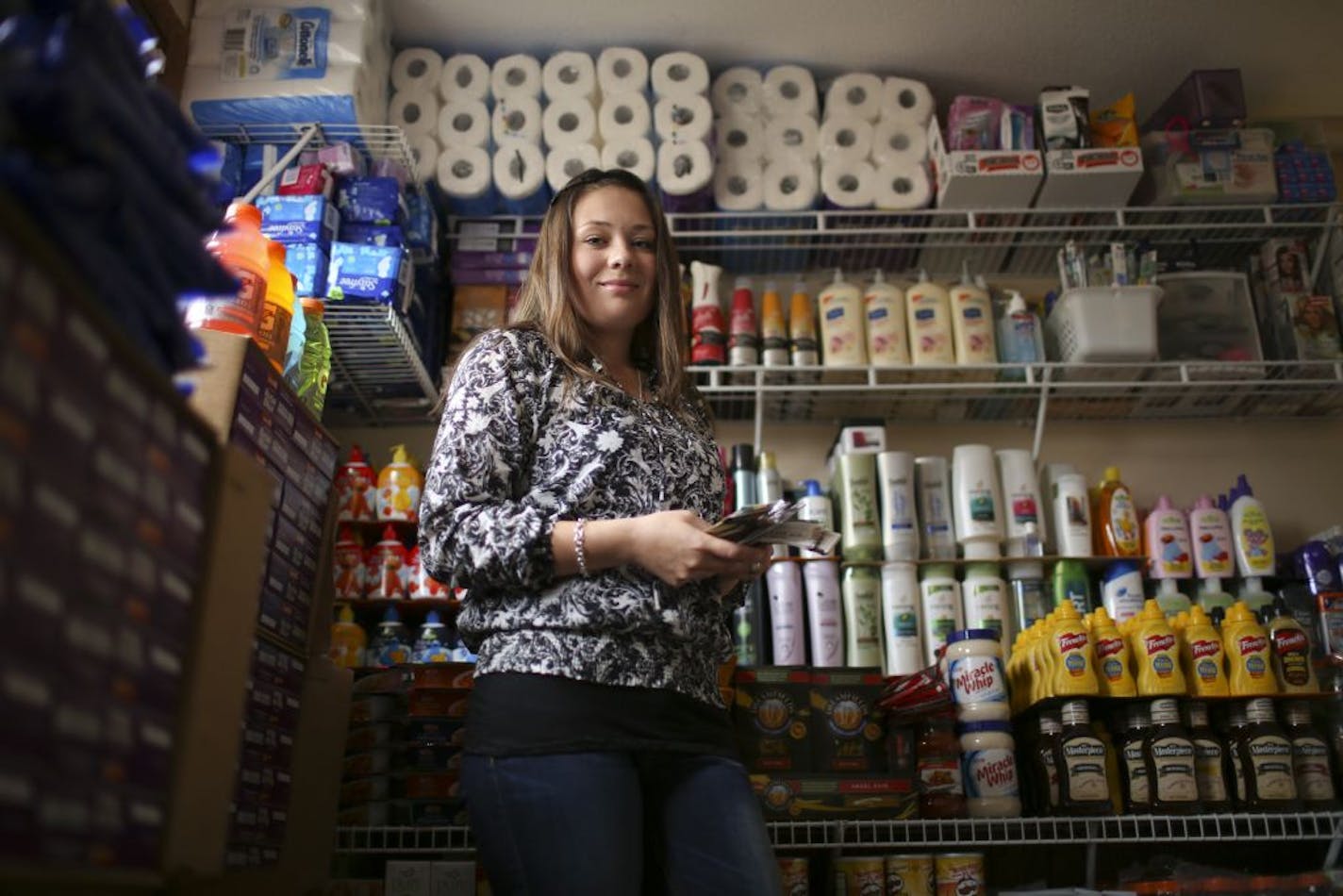 Natasha Moore, in her basement storage room Tuesday, is an extreme couponer. She has long had a system to maximize her grocery savings. "Sometimes, I'm there for four to five hours." But one analyst says bargain hunters aren't loyal to one store and questions if Rainbow will gain many lasting customers.