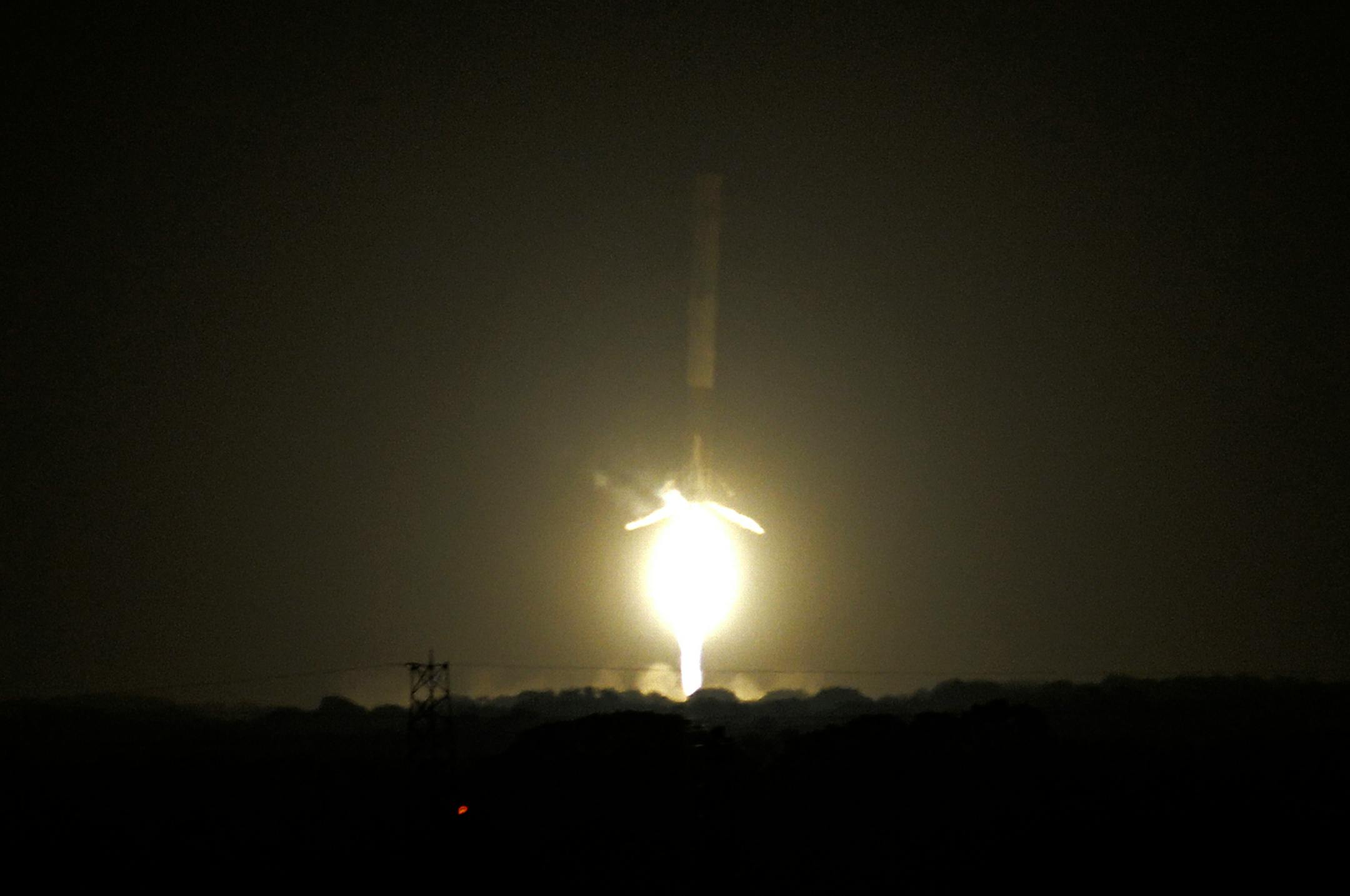 The SpaceX Falcon 9 rocket successfully lands at historic Complex 13 at Cape Canaveral Air Force Station, Monday, Dec. 21, 2015. The rocket, carrying 11 communications satellites for Orbcomm, Inc., is the first launch of the rocket since a failed mission to the International Space Station in June. (Craig Bailey/Florida Today via AP)