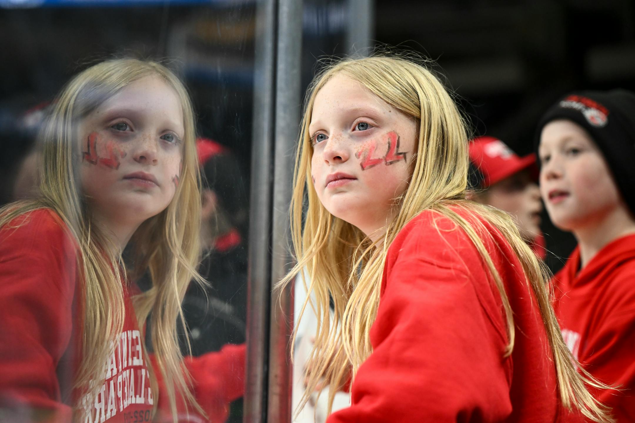 Payton Molin, 8, daughter of Centennial/Spring Lake Park head coach Sean Molin, waits for a 2A girls' state tournament quarterfinal game to start.