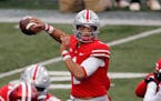 FILE - Ohio State quarterback Justin Fields throws a pass against Indiana during the first half of an NCAA college football game in Columbus, Ohio, in