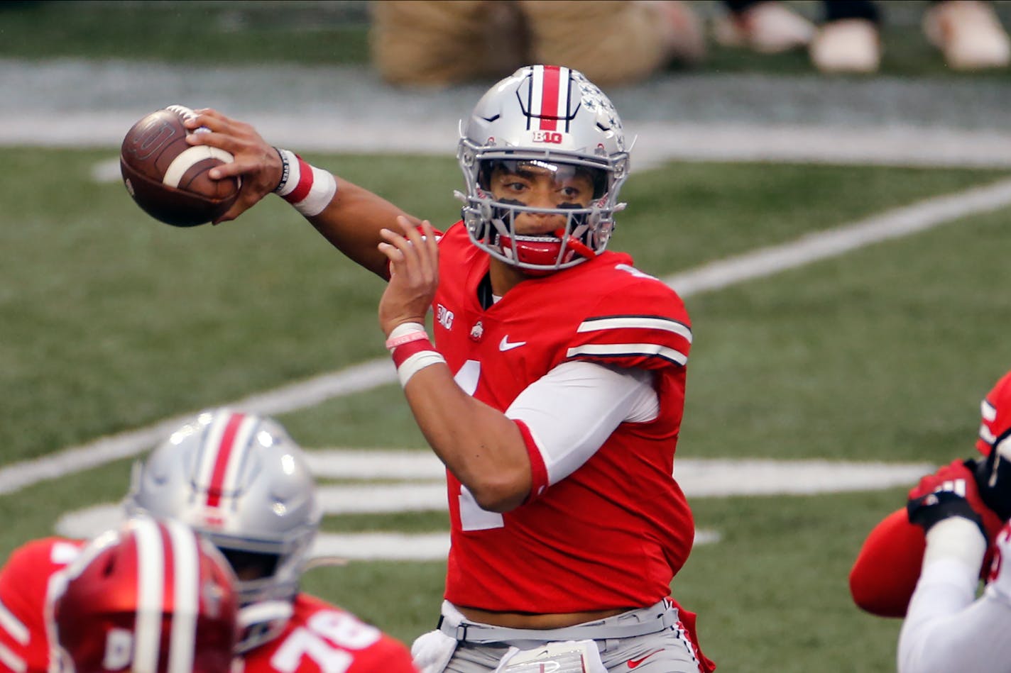 FILE - Ohio State quarterback Justin Fields throws a pass against Indiana during the first half of an NCAA college football game in Columbus, Ohio, in this Saturday, Nov. 21, 2020, file photo. Fields threw a Sugar Bowl-record six touchdown passes and accumulated 385 yards passing in the third-ranked Buckeyes' 49-28 College Football Playoff semifinal victory over No. 2 Clemson. (AP Photo/Jay LaPrete, File)