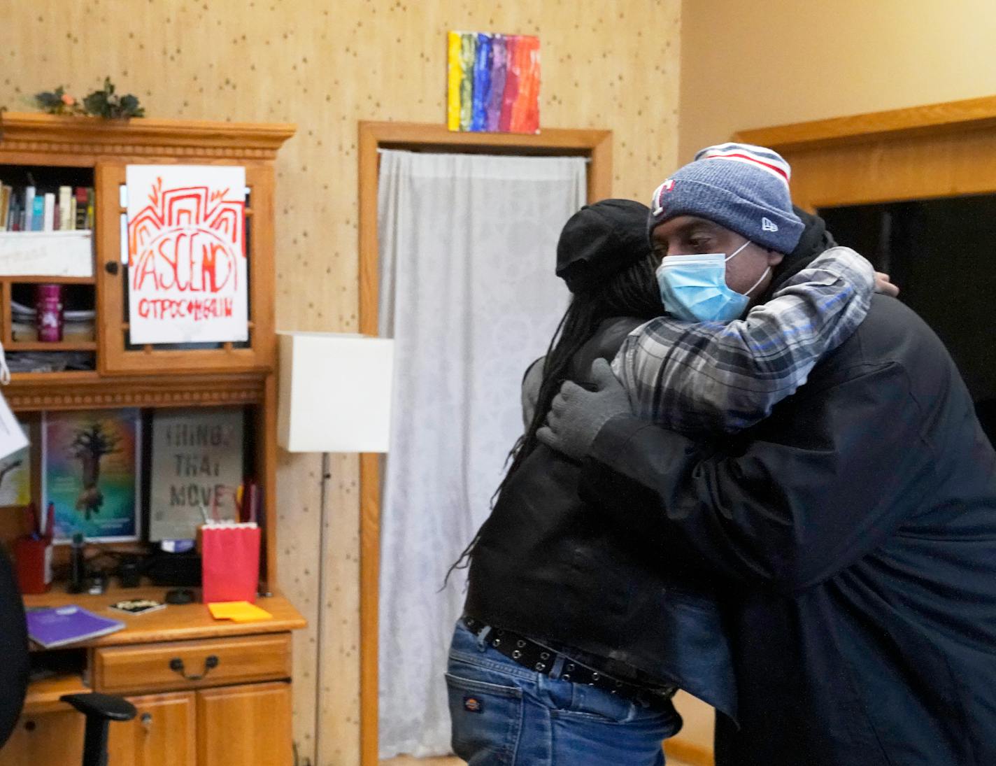 A year ago, Douglas Pyle was trapped in a downward spiral of homelessness and substance abuse. Now he has his own apartment and his addiction is in check, thanks in part to a $12 initiative to get the homeless off the streets and sheltered starting last March at the start of the pandemic. Here, Pyle got a hug his sister Roxanne Anderson after visiting her at her work place Tuesday in Minneapolis. ]