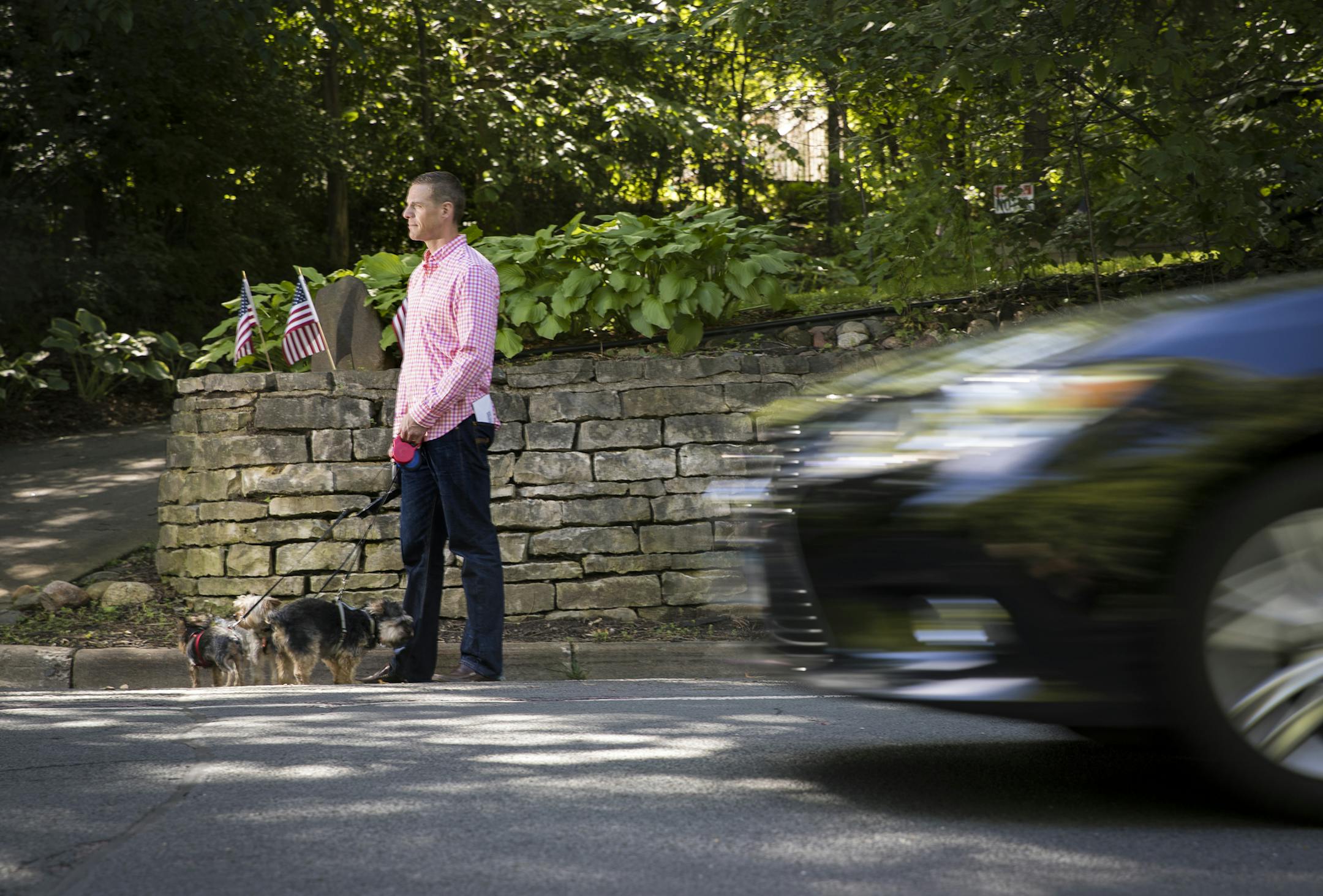 Josh Ahlberg has petitioned his neighborhood trying to get the city to put a sideway on his busy street Valley View Road. He posed for a picture with his dogs on Tuesday, July 12, 2016 in Edina, Minn. ] RENEE JONES SCHNEIDER ï reneejones@startribune.com