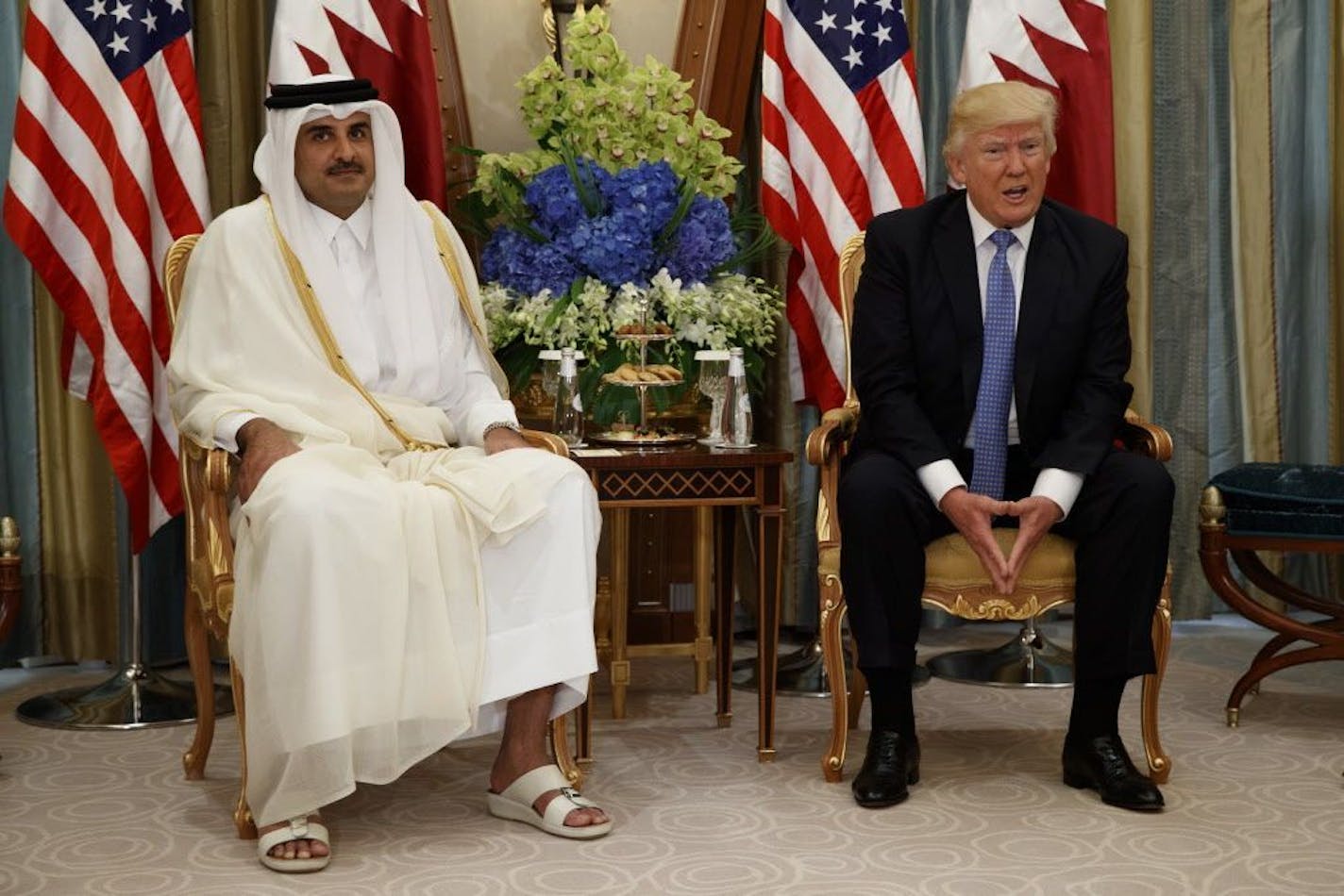 FILE -- In this May 21, 2017, file photo, U.S. President Donald Trump, right, holds a bilateral meeting with Qatar's Emir Sheikh Tamim Bin Hamad Al-Thani, in Riyadh, Saudi Arabia. On Monday, June 5, 2017, Bahrain, Egypt, Saudi Arabia and the United Arab Emirates cut diplomatic ties to Qatar, further deepening a rift between Gulf Arab nations over that country's support for Islamist groups. The crisis comes after Trump's recent visit to Saudi Arabia for a summit with Arab leaders.