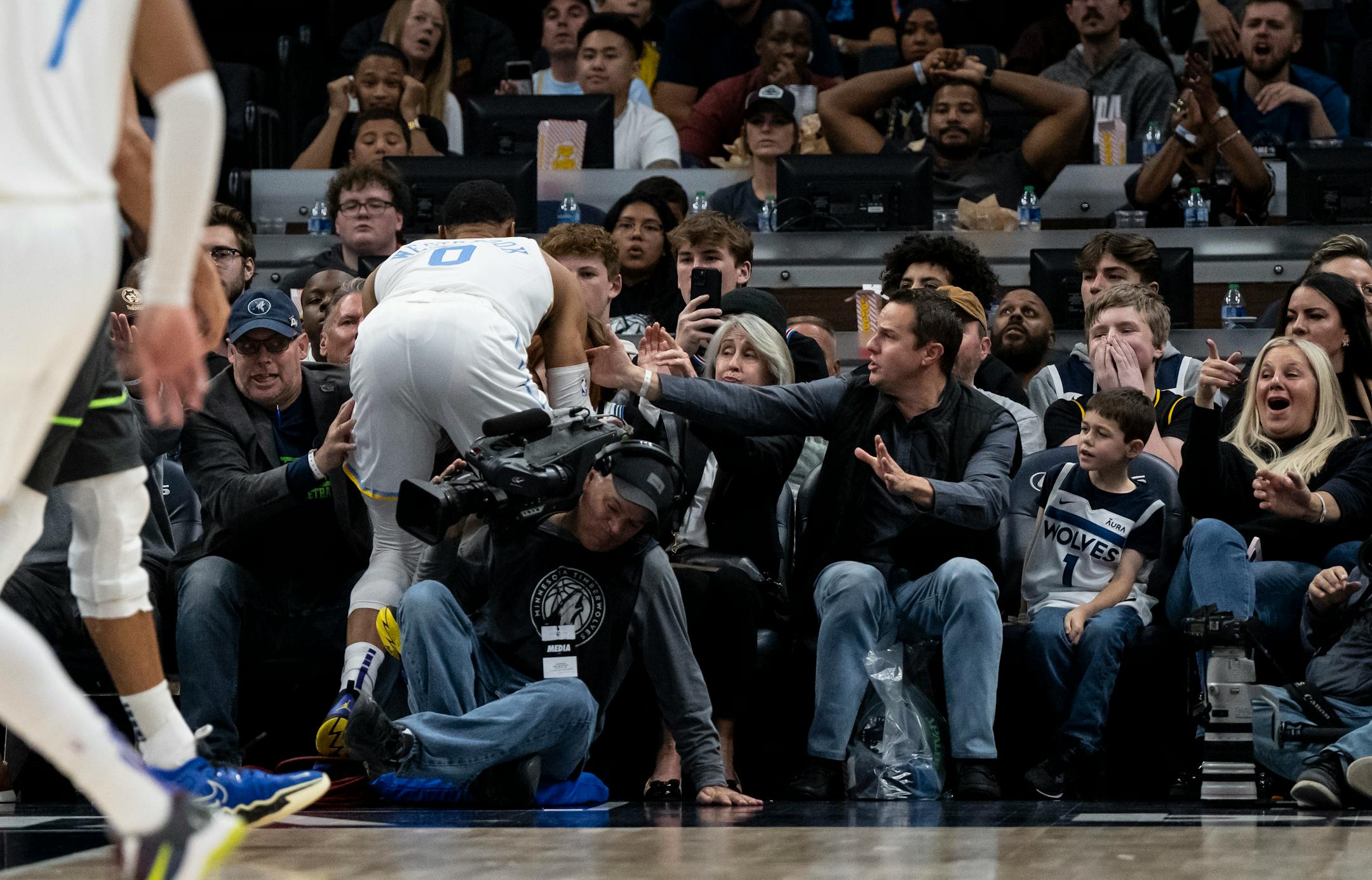Los Angeles Lakers guard Russell Westbrook (0) falls into the crowd in the fourth quarter.