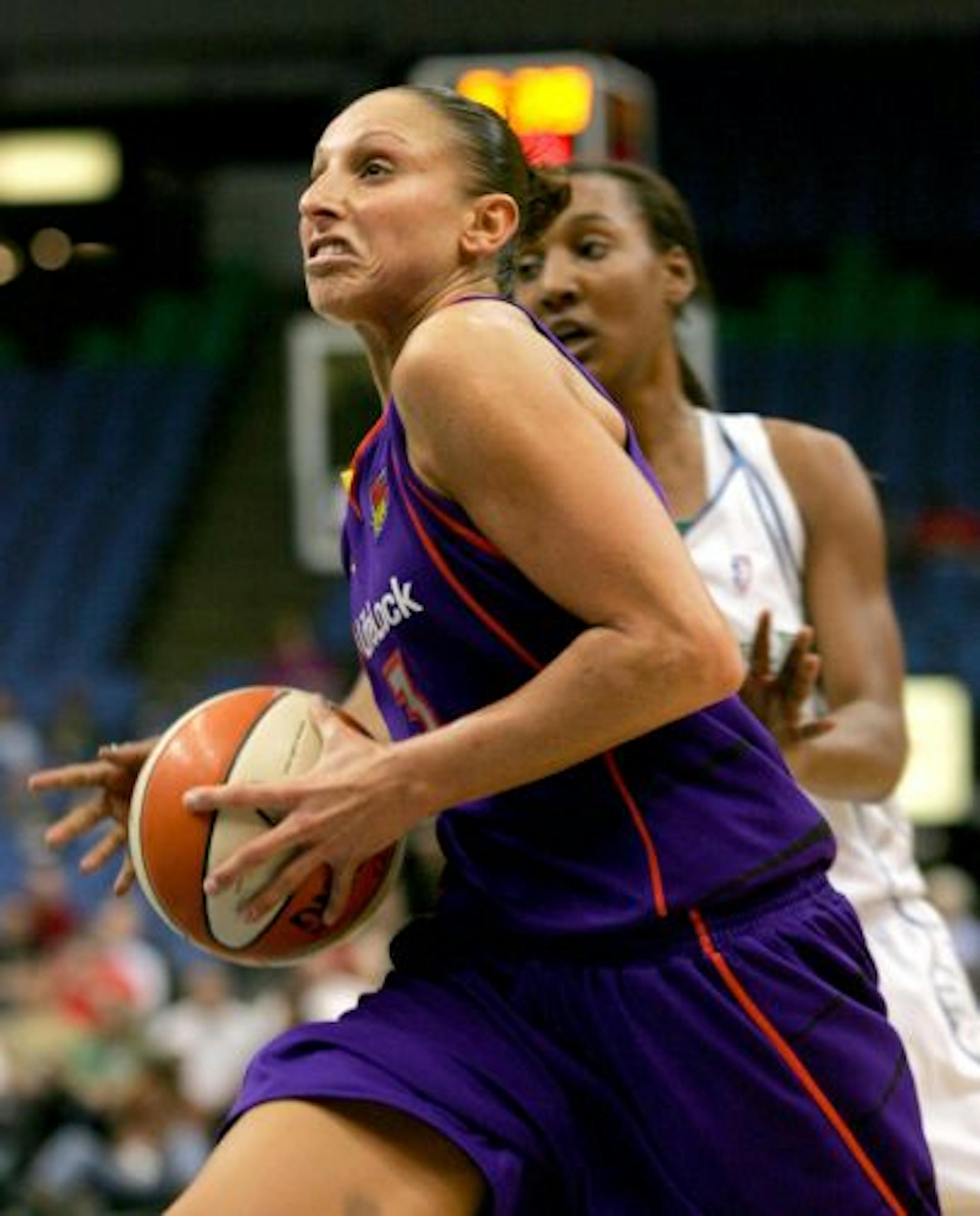 Phoenix Mercury forward Diana Taurasi, foreground, drives on Minnesota Lynx Candice Wiggins in the third quarter of their WNBA basketball game Saturday, Aug. 1, 2009, in Minneapolis.
