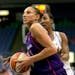 Phoenix Mercury forward Diana Taurasi, foreground, drives on Minnesota Lynx Candice Wiggins in the third quarter of their WNBA basketball game Saturda