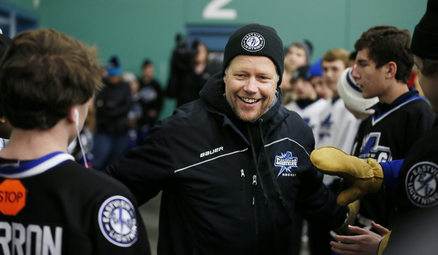 Mike Schoonover shook hands with Eastview hockey players as they welcomed the team to the ice at Hayes Arena in Apple Valley on Sunday. Mike's 14-year-old son, Patrick, died Friday after collapsing on the ice. It was later discovered that the cause of death was from heart defects.